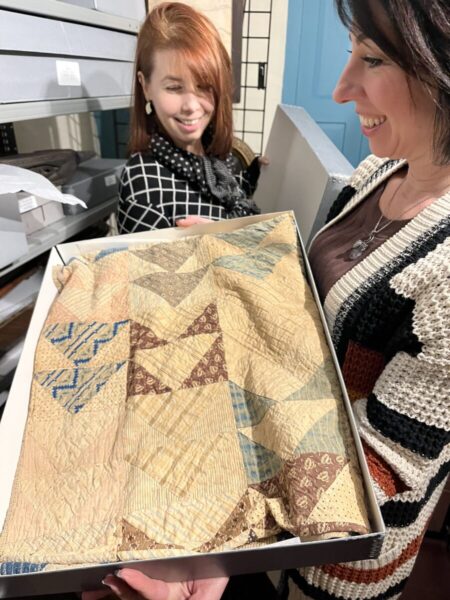 American Independence Museum Staff looking at Indigenous artifacts in collection
