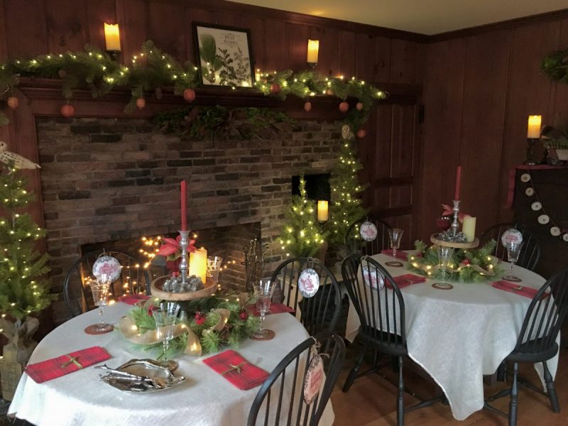 Two tables decorated for a winter holiday event.