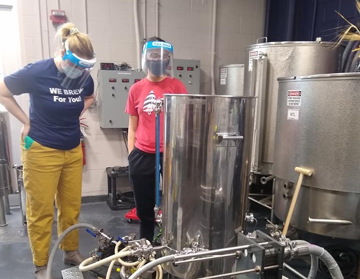 Two students at work brewing beer in the UNH Labs