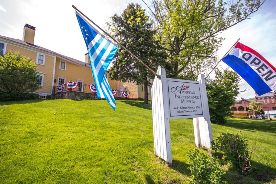 American Independence Museum sign with two flag on either side, the Society of the Cincinnati Flag and an Open Flag