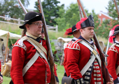 Reenactors dressed in uniforms belonging to the King's Own Fourth Regiment of the Foot