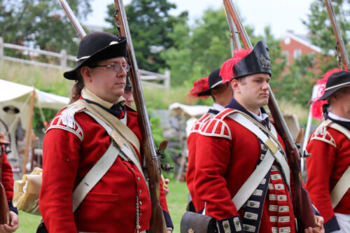Reenactors dressed in uniforms belonging to the King's Own Fourth Regiment of the Foot