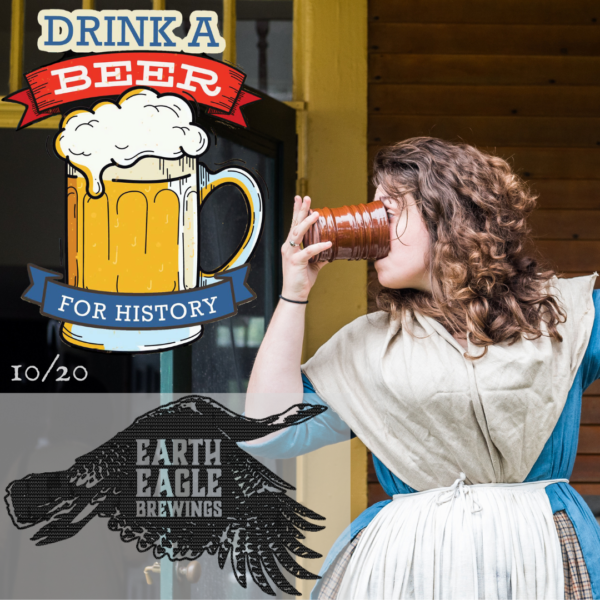 Woman in an 18th century blue dress with a white fichu over it drinks beer from a ceramic mug.